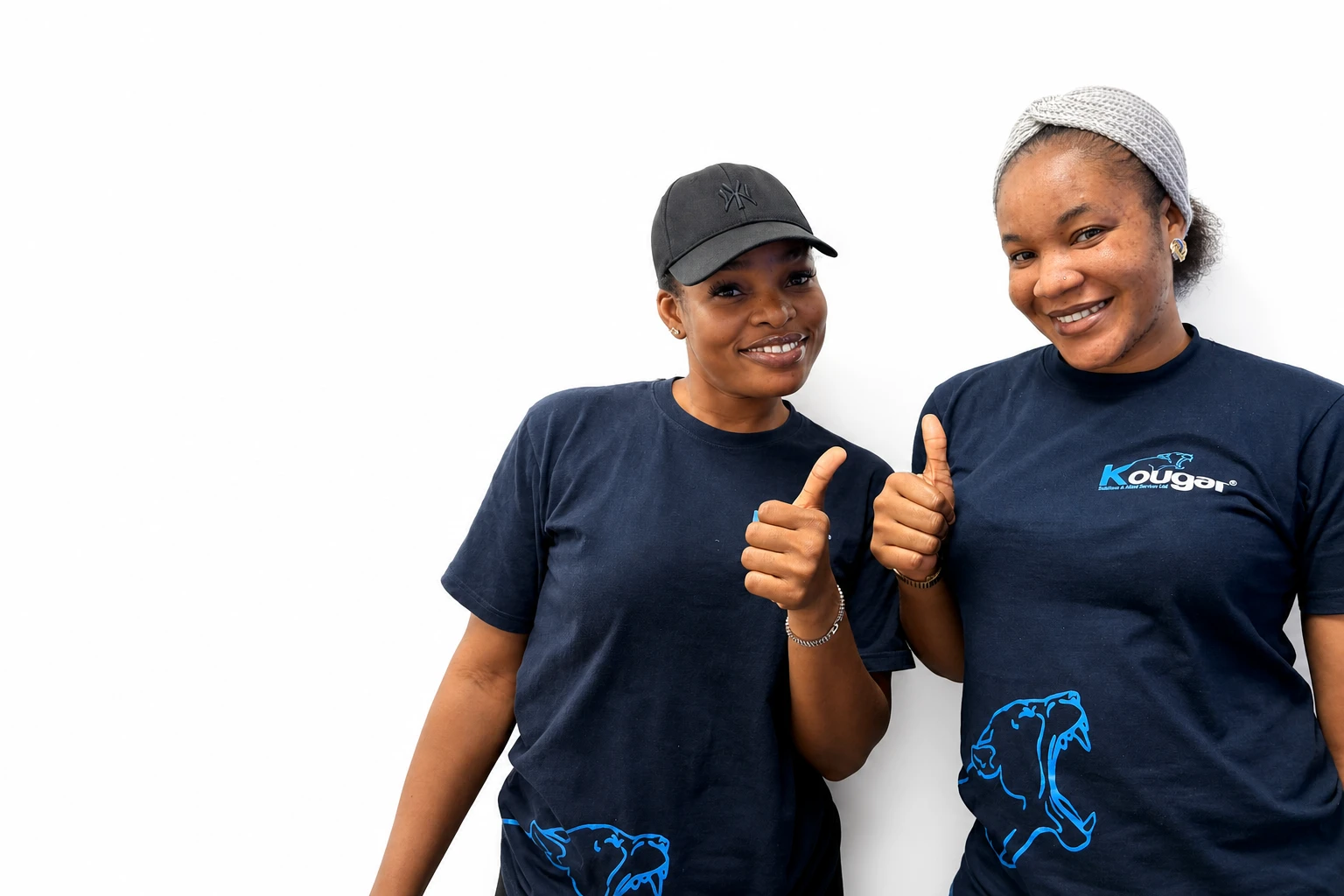 Two Kougar team members smiling and giving a thumbs-up in their navy Kougar shirts